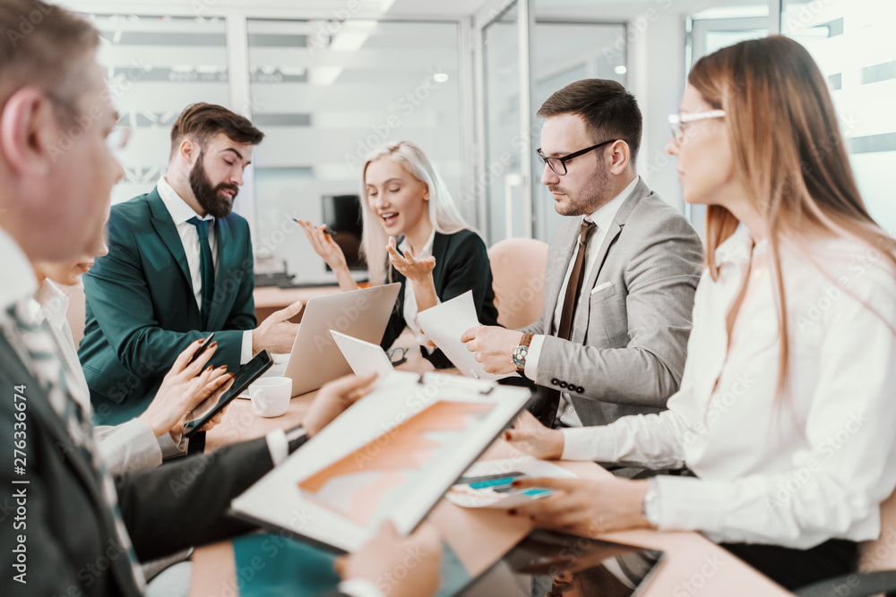 Group of dedicated business people dressed in suits having meeting at boardroom. Group of dedicated business people dressed in suits having meeting at boardroom.
