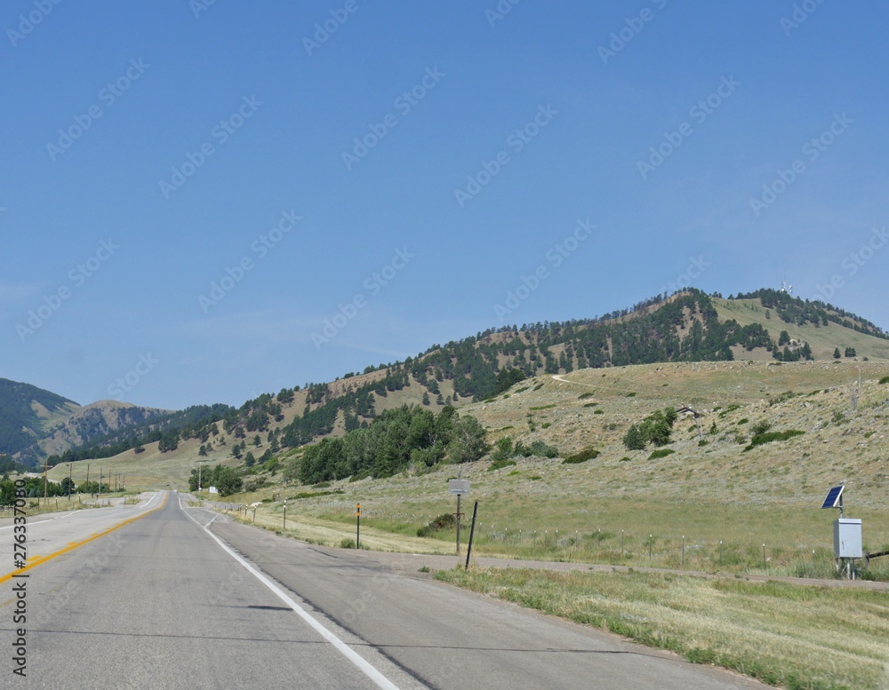 Road view along Interstate 90 with hills and valleys just past Buffalo, Wyoming.