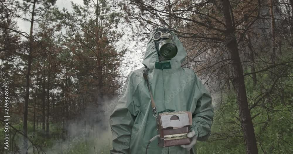 Man in WWII Hazmat suit and mask doing tests Man in WWII Hazmat suit and mask doing tests