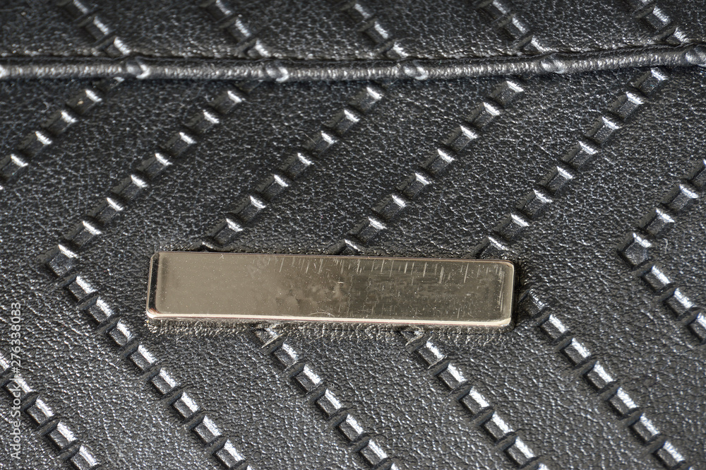 Fototapeta premium Texture of black artificial leather with embossed arrows