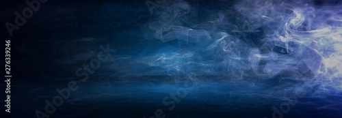 dark blue cement wall studio background with mist or fog, colorful smoke backdrop © khwanchai
