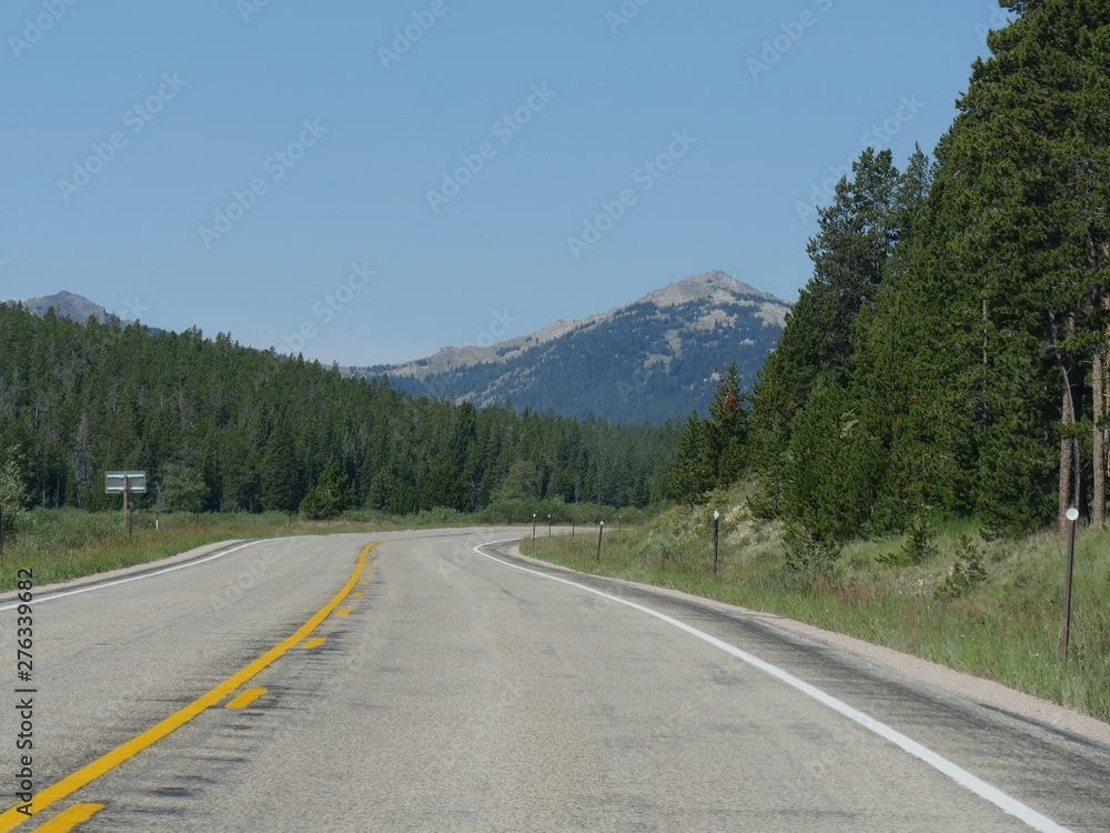 Wide scenic view of nature along Highway 16 through Bighorn National Forest mountain ranges in Wyoming. Wide scenic view of nature along Highway 16 through Bighorn National Forest mountain ranges in Wyoming.