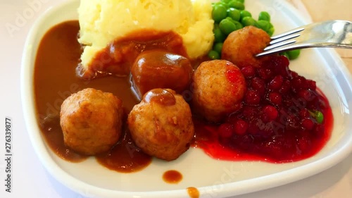 Porcelain plate with chicken  meatball and cowberry jam
