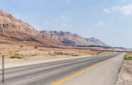 Panoramic view of the road, coast of Dead Sea and mountains in the Judean Desert in the Dead Sea region in Israel