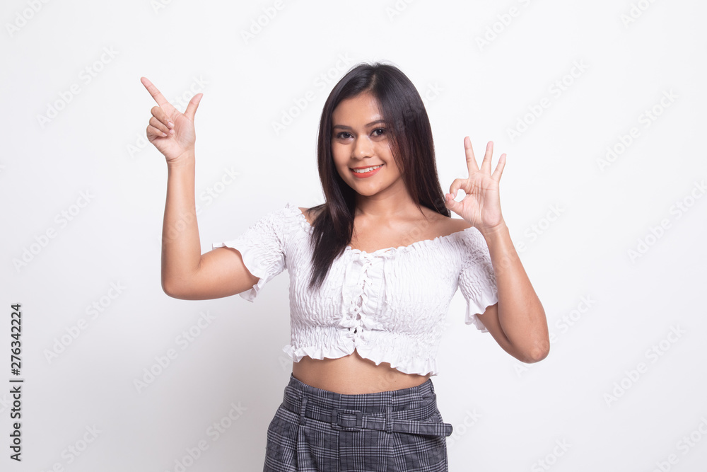 Young Asian woman point and show OK. Young Asian woman point and show OK.