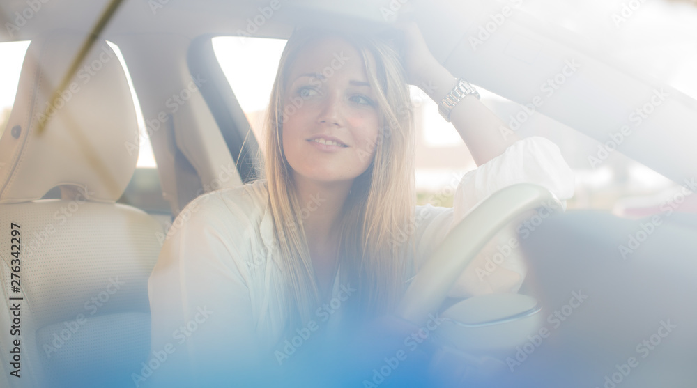 Pretty, young woman driving a car -Invitation to travel. Car rental or vacation. Pretty, young woman driving a car -Invitation to travel. Car rental or vacation.