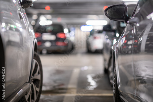 Underground garage or modern car parking with lots of vehicles, perspective photo