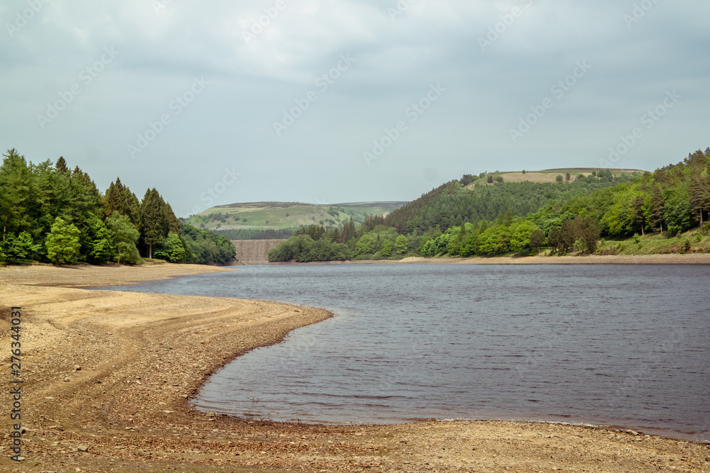 Upper Derwent Reservoir with distant dam wall and stony beach in the Peak District National Park Upper Derwent Reservoir with distant dam wall and stony beach in the Peak District National Park