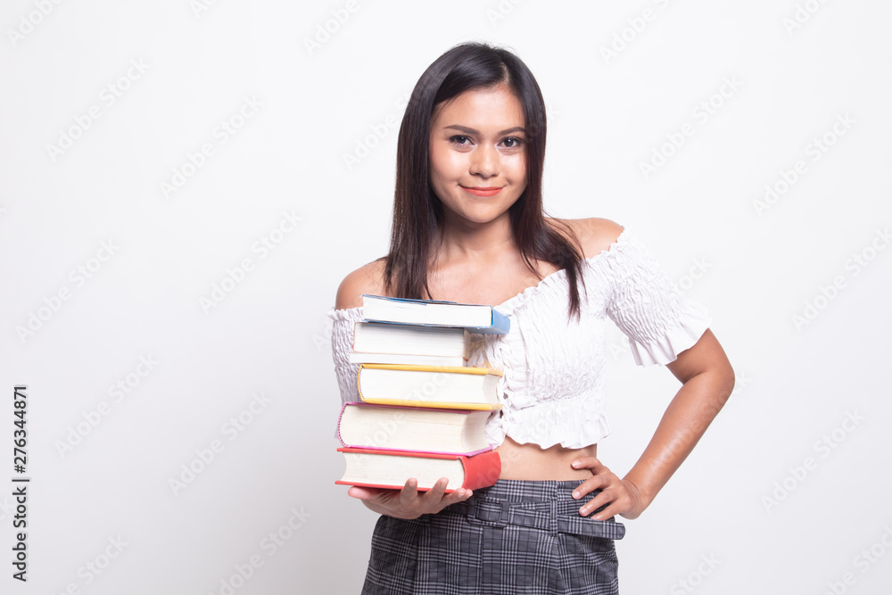 Young Asian woman studying with may books. Young Asian woman studying with may books.
