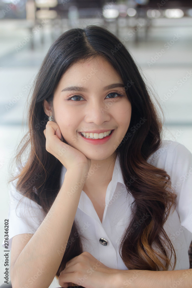 Portrait of thai adult student university uniform beautiful girl relax and smile Portrait of thai adult student university uniform beautiful girl relax and smile