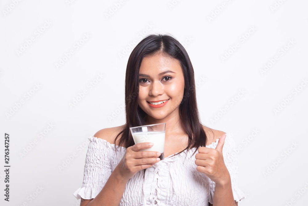 Healthy Asian woman drinking a glass of milk thumbs up. Healthy Asian woman drinking a glass of milk thumbs up.