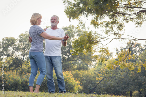 Senior couples dance together in the park. © P Stock