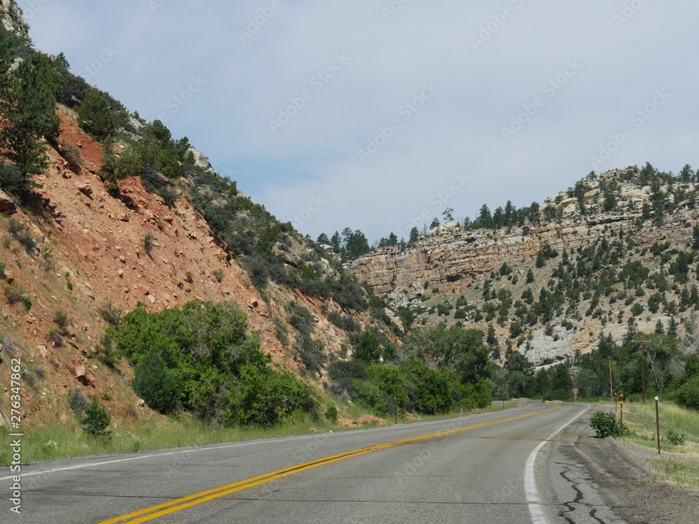 High mountains and geologic formations along a winding road at Bighorn Basin approaching Ten Sleep in Wyoming.