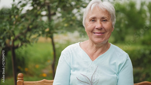 Portrait of an old woman on nature photo