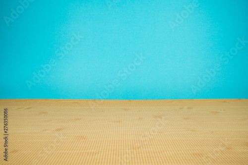 Corrugated paper with wood pattern on the base and blue paper to background.