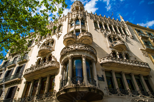BARCELONA, CATALONIA - APRIL 2019: Passeig de Gracia in Barcelona, Catalonia. It one of major avenue in city. Located in the Eixample district. Shopping and business areas photo