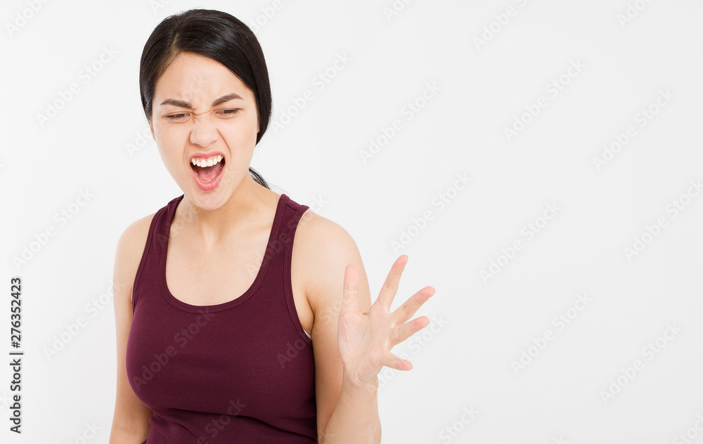 Angry Asian woman shouting to the front with mouth wide open on isolated white background Angry Asian woman shouting to the front with mouth wide open on isolated white background
