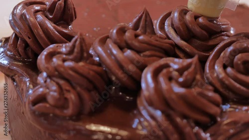 decorate chocolate cake with a pastry bag. chocolate curls, pastry decorations, chocolate