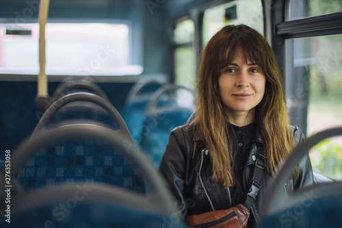 A portrait of a young woman in the bus.