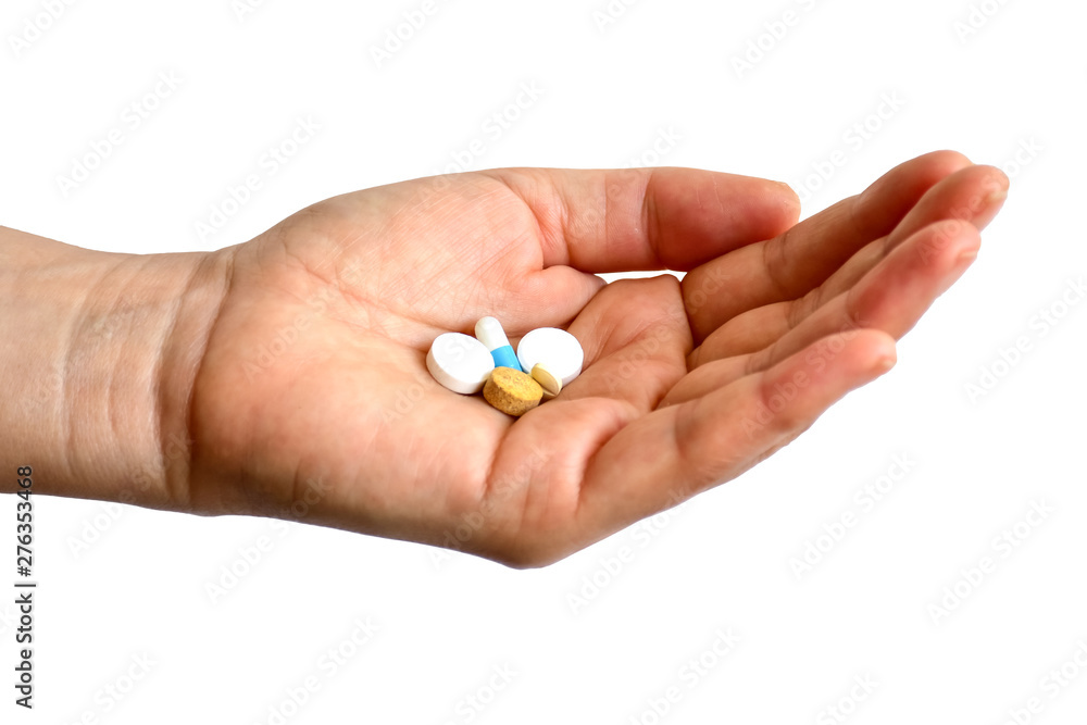 Female hand with pills isolated on white background, time to take medicine. Female hand with pills isolated on white background, time to take medicine.