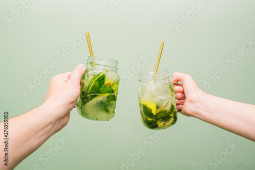 Mojito cocktail in a glass beaker. People keep in their crawfish a summer cold drink with lime, mint and ice. The concept of relaxation and good mood photo