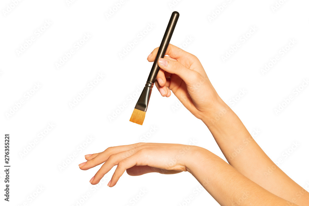 Shader brush in woman's hand isolated on white Shader brush in woman's hand isolated on white