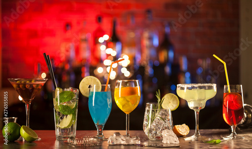 Set with different cocktails on bar tender