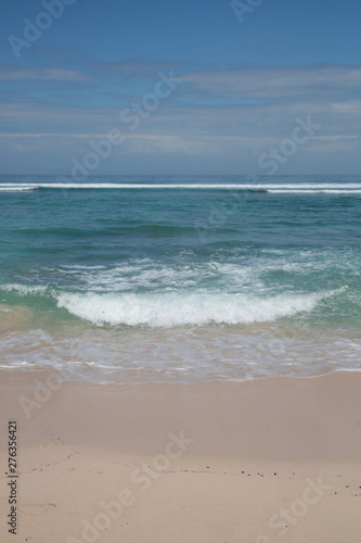 View from a beautiful white sandy beach on the ocean horizon and blue sky 