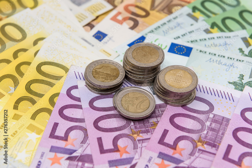 Euro cent coins on colorful banknotes close up Euro cent coins on colorful banknotes close up