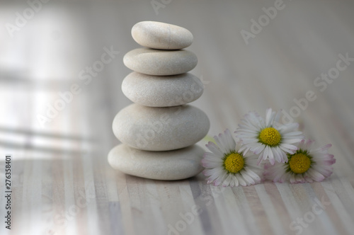 Harmony and balance, cairns, simple poise pebbles on wooden light white gray background, simplicity rock zen sculpture