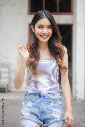 Portrait of thai adult beautiful girl White shirt blue jeans relax time