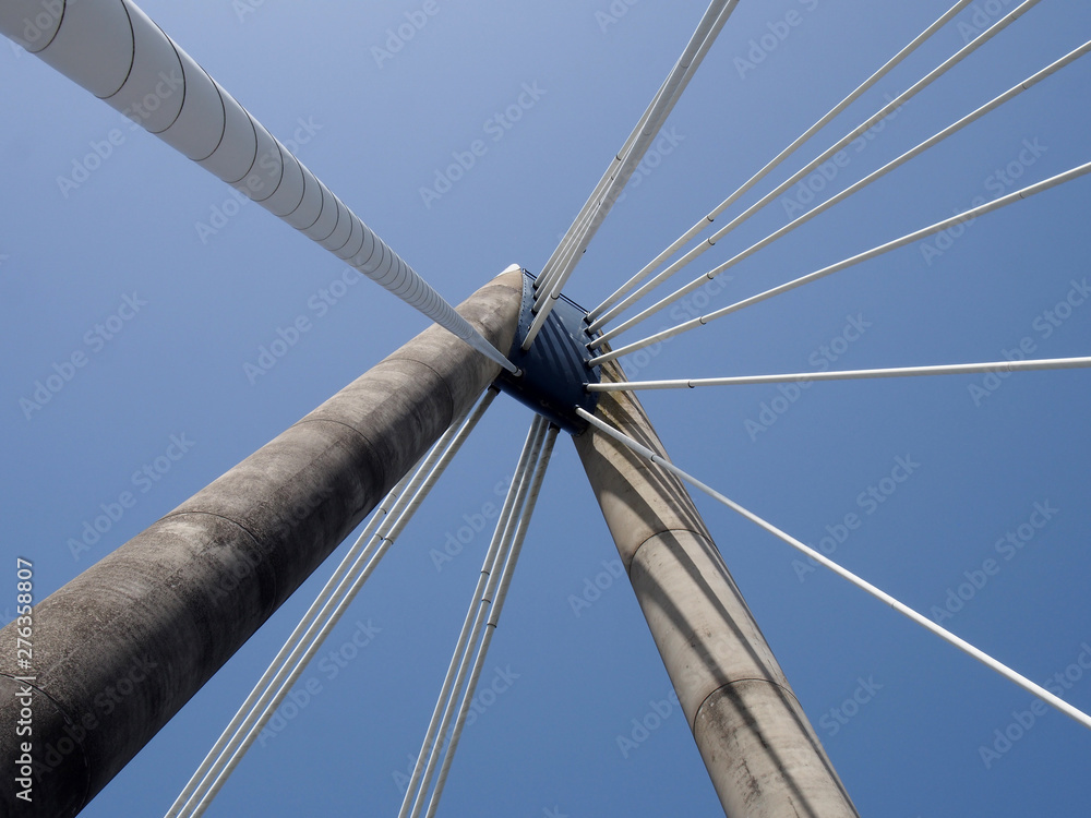 geometric close up of the supports and cables of the suspension bridge in southport merseyside against a blue sky