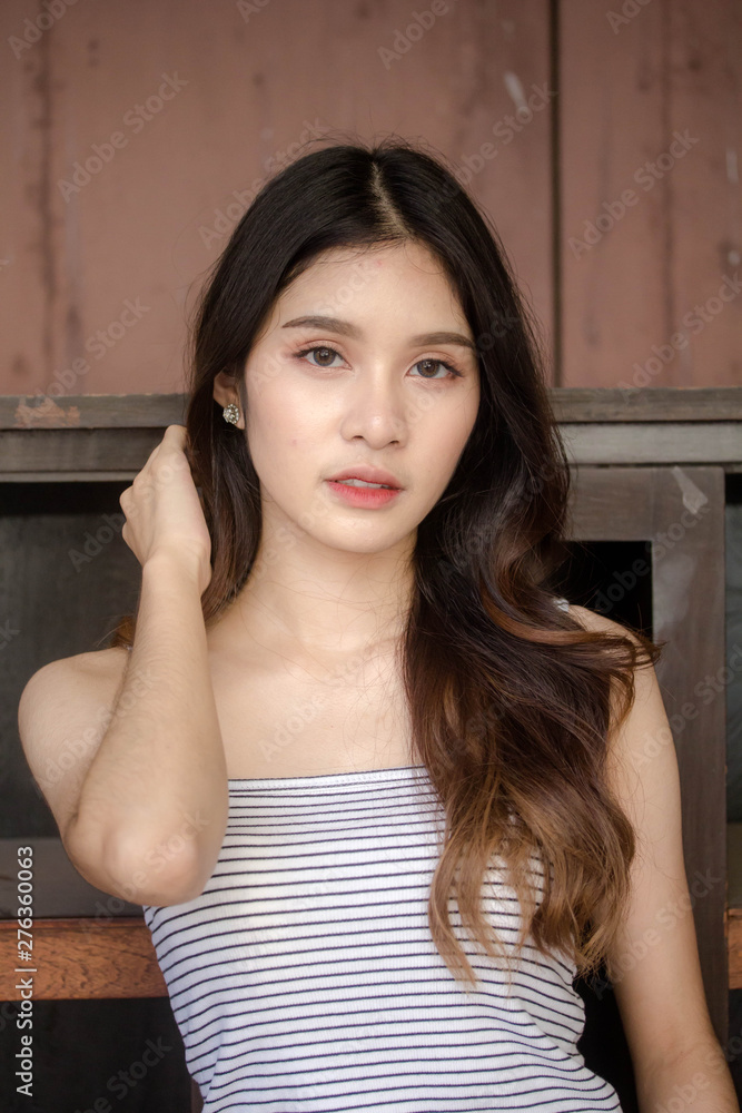 Portrait of thai adult beautiful girl White shirt blue jeans relax time Portrait of thai adult beautiful girl White shirt blue jeans relax time