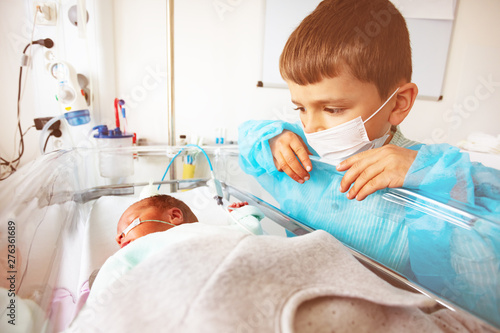 Little boy with premature infant brother, hospital photo