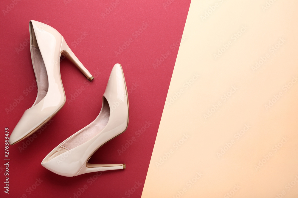 Beige high heel shoes on colorful background Beige high heel shoes on colorful background