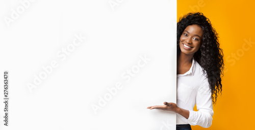African-american man pointing at white blank board