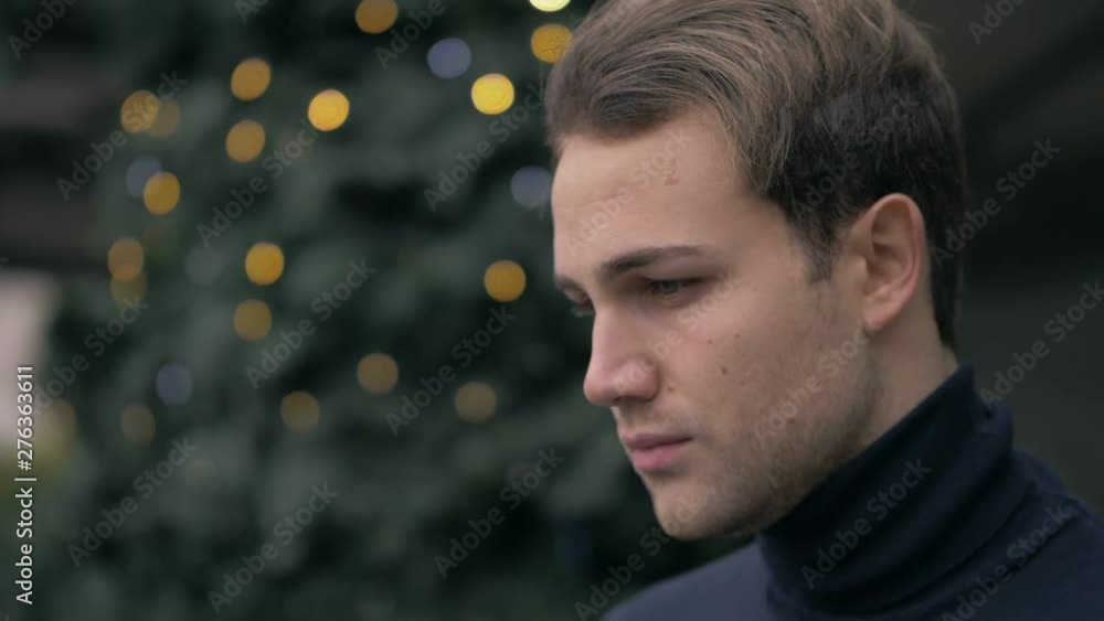 pensive Attractive young man looking up at Christmas time.Hope,wishes-slow motio pensive Attractive young man looking up at Christmas time.Hope,wishes-slow motio