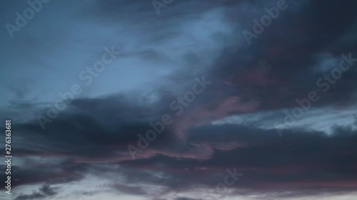 Rain clouds fly fast in the sky, night falls.