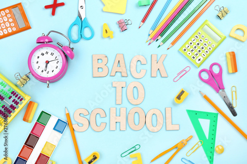 Text Back To School with stationery on blue background