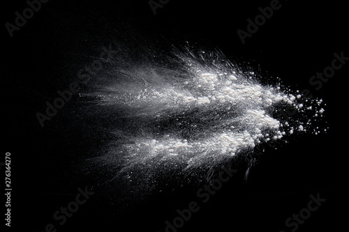 Color powder white splashes dust on a black background.
