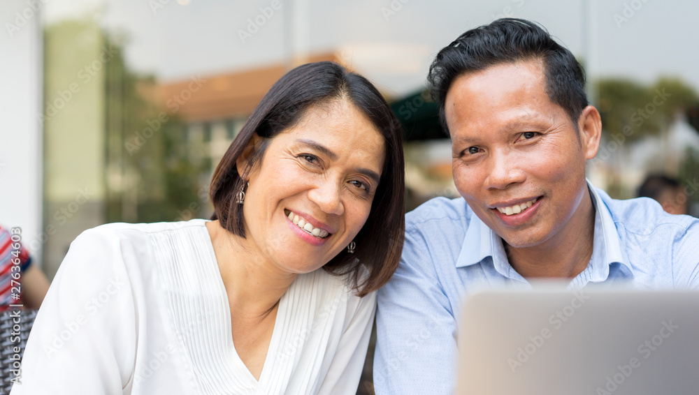 close up on asian couple lover smiling with happy feeling at outside department store in weekend day and , mature love relationship concept close up on asian couple lover smiling with happy feeling at outside department store in weekend day and , mature love relationship concept