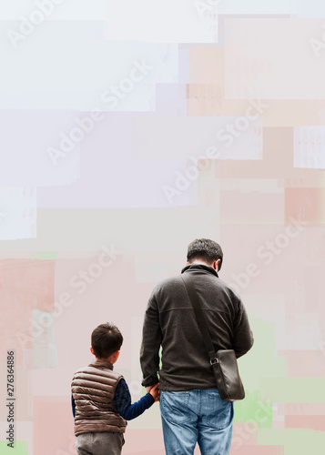 Man with son holding hands