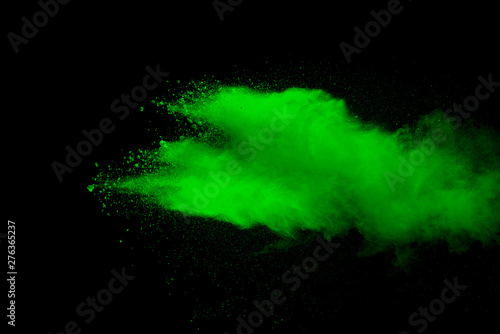 Explosion of green dust on black background.