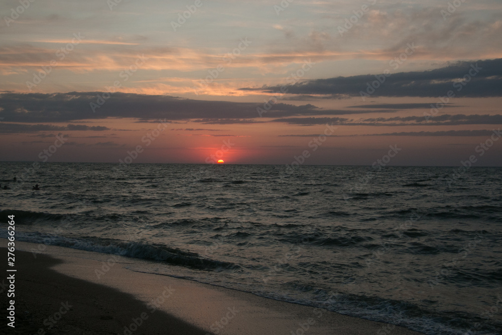 The setting sun going beyond the horizon of the Azov sea The setting sun going beyond the horizon of the Azov sea