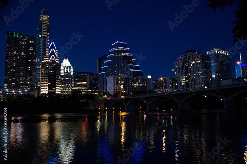Austin skyline over Colorado river at night, Texas.
