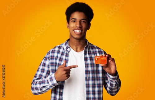 Happy Guy Holding Credit Card and Point on It