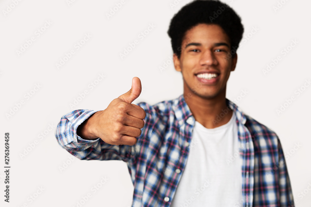 I Recommend It. Overjoyed Afro Guy Showing Thumb Up I Recommend It. Overjoyed Afro Guy Showing Thumb Up