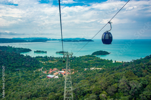 Aerial view of cable car ride in langkawi island with mountains, tropical forest and blue ocean background