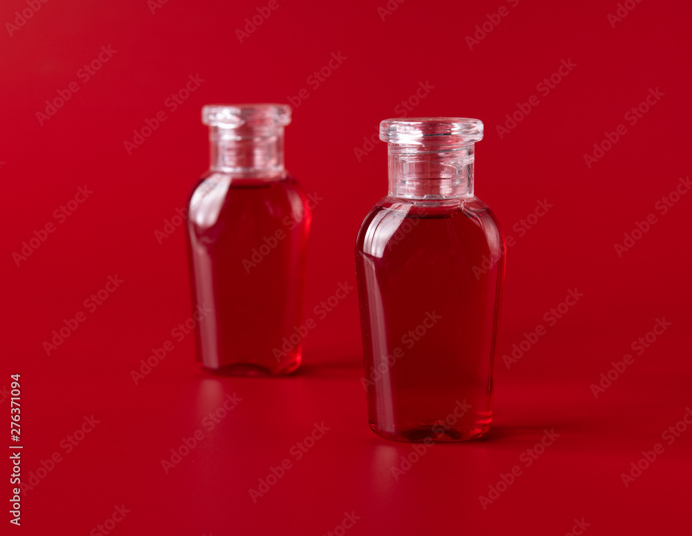 Shampoo and shower gel against red background Shampoo and shower gel against red background