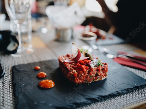 Steak tartare served on stone plate.